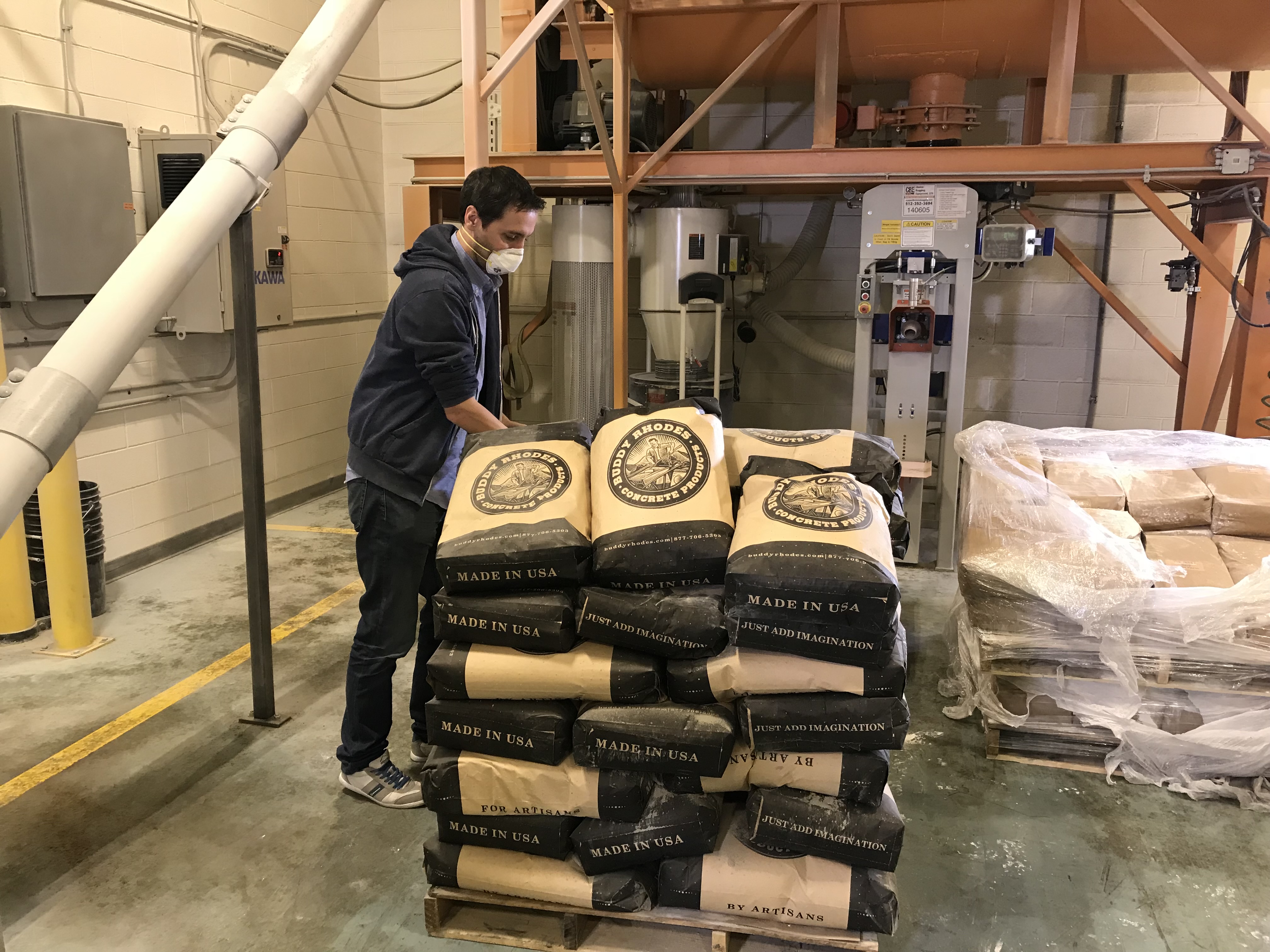 Stacking bags of Buddy Rhodes Concrete Mix at the factory