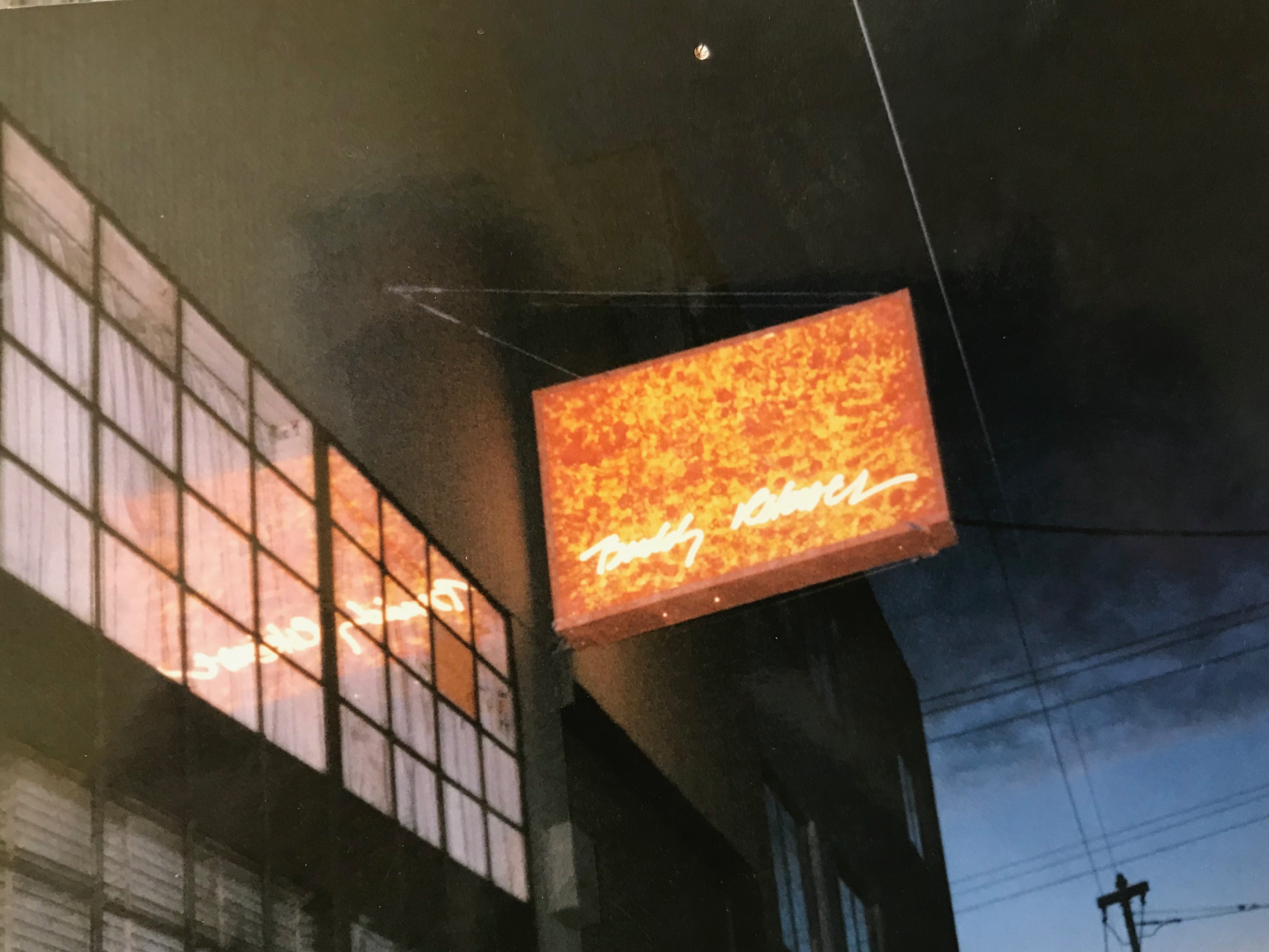 Buddy Rhodes Studio sign illuminated at night