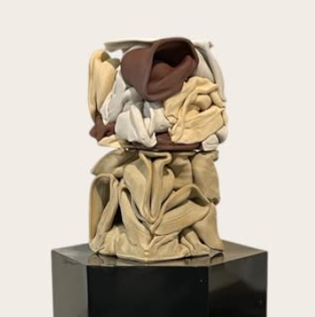 Draped ceramic vessel on pedestal