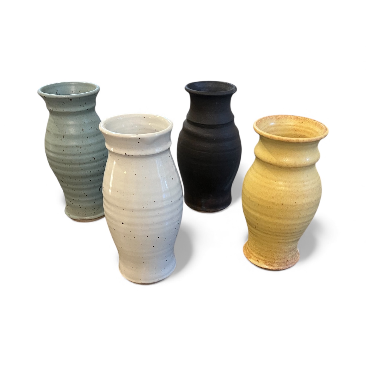 Four vases in sage, white, black, and yellow glazes